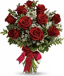 Ten Highest Quality Red Roses decorated with seasonal greenery