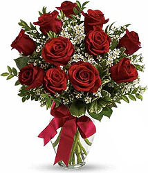 Eleven Highest Quality Red Roses decorated with seasonal greenery