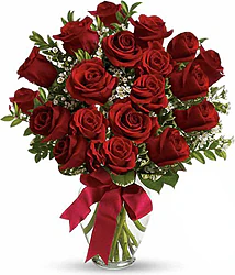 Nineteen Highest Quality Red Roses decorated with seasonal greenery