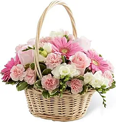 Basket of pastel gerberas, freesias and mixed flowers