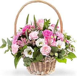 Basket of lively mixed flowers with lilies and daisies