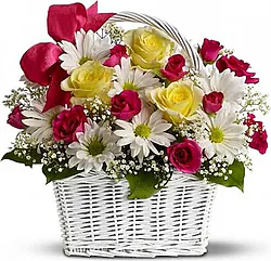 Basket of bright roses, daisies or gerberas and mixed flowers