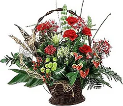Basket of roses, anthuriums and mixed flowers in warm colors