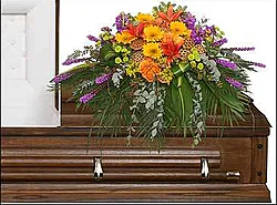 Bright funeral spray of roses, lilies, gerberas and mixed flowers