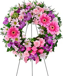 Bright funeral wreath of gerberas and/or daisies, carnations and mixed flowers