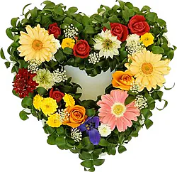 Bright heart arrangement of roses, gerberas and mixed flowers