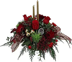 Christmas centerpiece of roses, gerberas and mixed flowers in warm colors