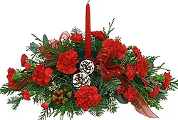 Christmas centerpiece of mixed flowers in warm colors