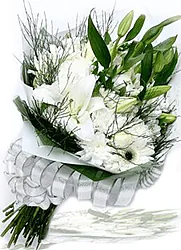 Funeral White Lilies arrangement with seasonal greenery