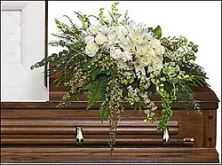 Delicate funeral spray of roses, lilies, carnations and mixed flowers