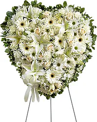Delicate funeral spray of roses, lilies, gerberas and mixed flowers