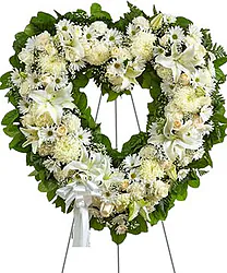 Delicate funeral wreath of lilies, daisies and mixed flowers