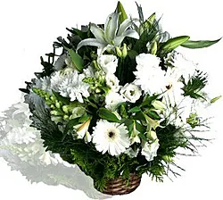 Funeral basket of delicate gerberas, lilies, lisianthuses and mixed seasonal flowers