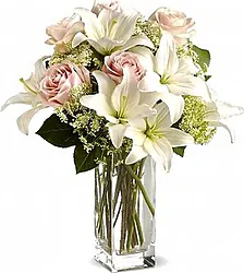 Funeral Roses and Lilies Bouquet decorated with seasonal greenery