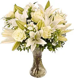 Funeral bunch of roses, lilies and mixed flowers in light colors