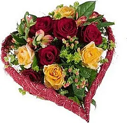 Funeral heart of roses and mixed flowers in warm colors