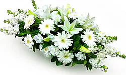 Funeral spray of delicate gerberas, lilies and mixed flowers