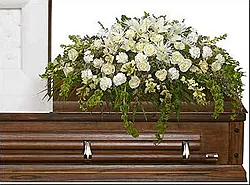 Funeral spray of delicate roses, lilies, carnations and mixed flowers