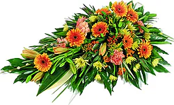 Cuscino funebre di gerbere, lilium, garofani e fiori misti dai toni accesi