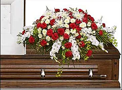 Funeral spray of red and white carnations and mixed flowers
