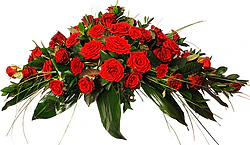 Funeral spray of red roses