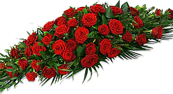 Funeral spray of red roses