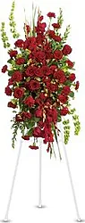 Funeral spray of roses and mixed flowers in warm colors