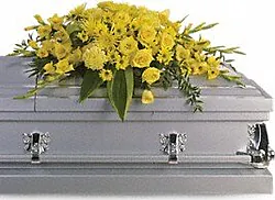 Funeral spray of yellow roses and daisies or gerberas