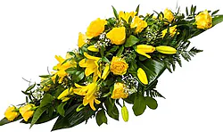 Funeral spray of yellow roses and lilies