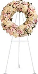 Funeral wreath of pastel roses, chrysanthemums and mixed flowers