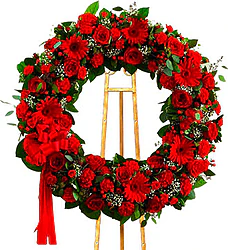 Funeral wreath of red roses, gerberas, carnations and mixed flowers