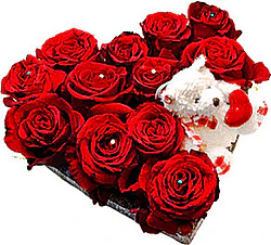 Heart arrangement of red roses and plush