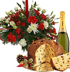 Christmas centerpiece of red and white roses and mixed flowers with panettone and sparkling wine