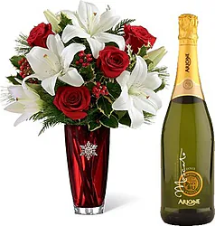 Red roses and light-colored lilies with sparkling wine or white wine