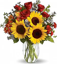 Sunflowers, roses, daisies or gerberas and mixed flowers in warm colors