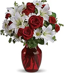 Rose Rosse Big di Prima Scelta con Lilium e Fiori Misti di Stagione. Elegante Confezione a tono con Verde decorativo. Un'Ottima scelta nelle Occasioni Importanti.